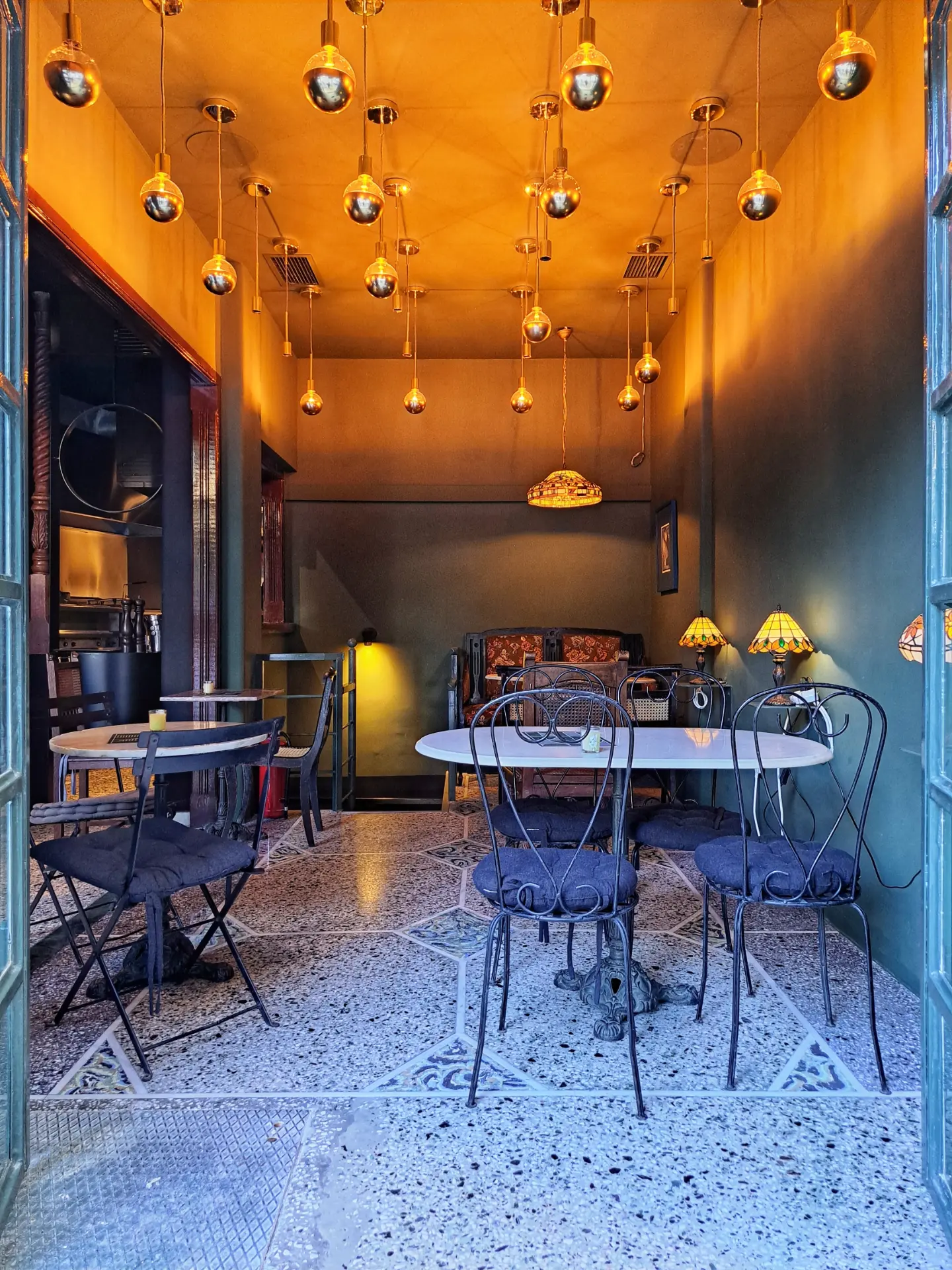 Inside the Mama Ghanoush falafel shop under hanging lights